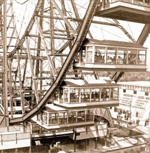 A sepia photo shows the box like cars that held multiple people in the original Ferris Wheel