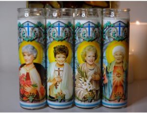 garland shop the frocksy is hosting what looks like traditional, catholic, virgin mary candles which are actually the Golden Girls when you get up close.