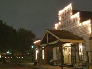 saloon pictured at night with the stepped false front outlined in big white xmas lights.