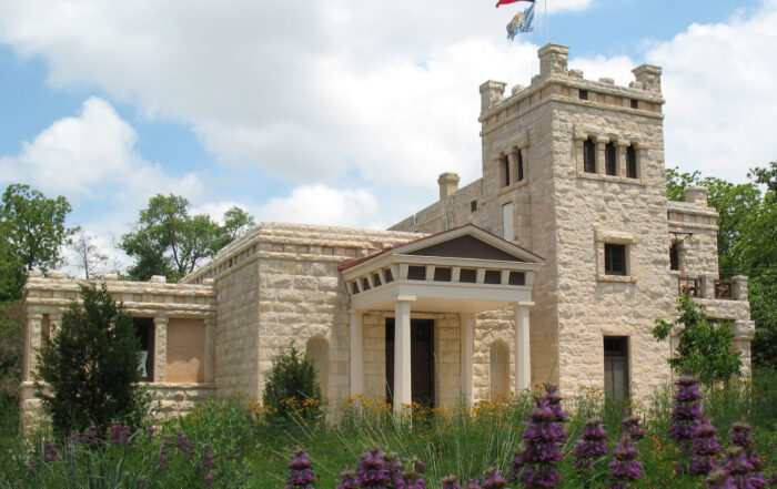 exterior shot of a very castle-like building with wild landscaping in keeping with the prairie lands this used to be